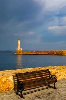 Panorama of venetian harbour waterfront and lighthouse in old harbour of Chania, Crete, Greece. Old venetian lighthouse in Chania, Greece. Lighthouse of the old Venetian port in Chania, Greece.