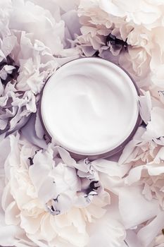 Luxe cosmetic cream jar as antiaging skincare routine product on background of peony flowers, body moisturizer and beauty branding design