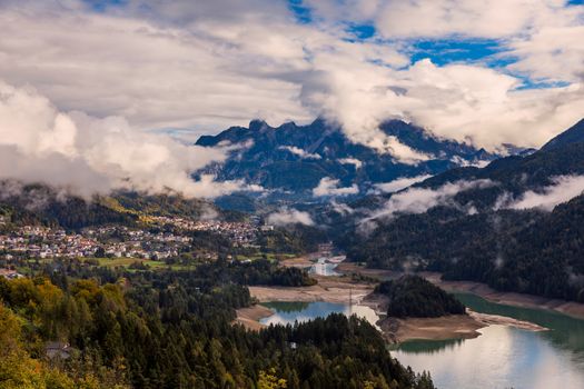 Panoramic view of lake of Centro Cadore in the Alps in Italy, Dolomites, near Belluno. View of Lake Calalzo, Belluno, Italy. Lake of Centro Cadore in the Alps in Italy, near Belluno.