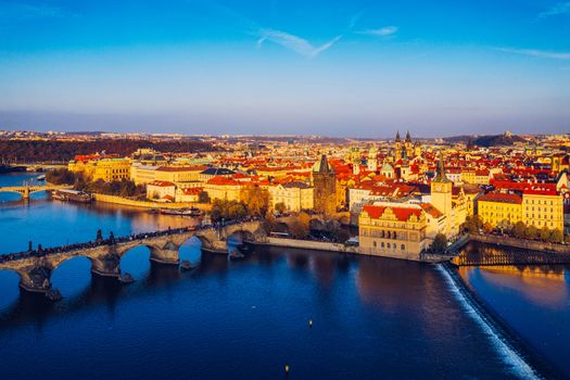 Aerial Prague panoramic drone view of the city of Prague at the Old Town Square, Czechia. Prague Old Town pier architecture and Charles Bridge over Vltava river in Prague at sunset, Czech Republic. 