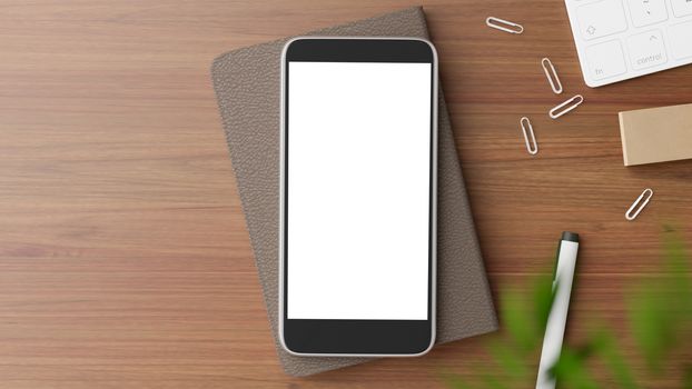 Copyspace of blank screen mockup mobile phone on wooden working table.