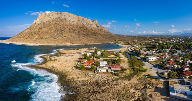 Aerial drone top view of turquoise organised beach forming a small heart shaped lagoon and mountainous seascape of Stavros, Chania, Crete island, Greece. Picturesque Stavros beach at Crete, Greece.
