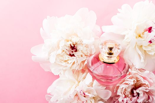 Luxurious fragrance bottle as chic perfume product on background of peony flowers, parfum ad and beauty branding design