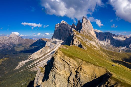 Drone view on Seceda peak. Trentino Alto Adige, Dolomites Alps, South Tyrol, Italy. Odle mountain range, Val Gardena. Majestic Furchetta peak. Odles group seen from Seceda, Santa Cristina Val Gardena.
