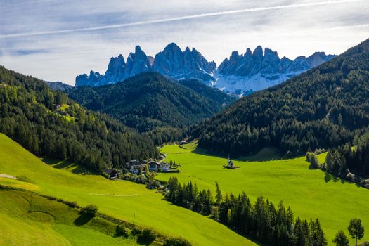Beautiful landscape with Italian Alps and Church of Saint John located in Ranui, Italy. Val di Funes, Bolzano, Italy. San Giovanni in Ranui church (St John in Ranui church) in the Dolomites, Italy.