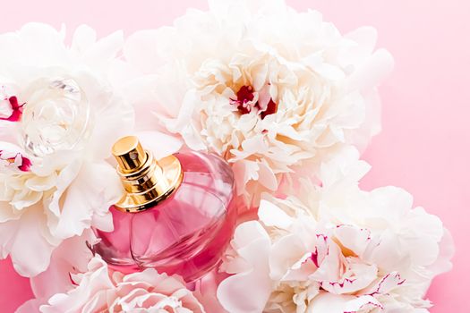 Luxurious fragrance bottle as chic perfume product on background of peony flowers, parfum ad and beauty branding design