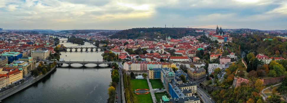 Aerial Prague panoramic drone view of the city of Prague at the Old Town Square, Czechia. Prague Old Town pier architecture and Charles Bridge over Vltava river in Prague at sunset, Czech Republic. 