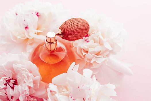 Vintage fragrance bottle as luxe perfume product on background of peony flowers, parfum ad and beauty branding design