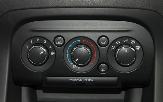 manual switches the air conditioning on the dashboard of the car