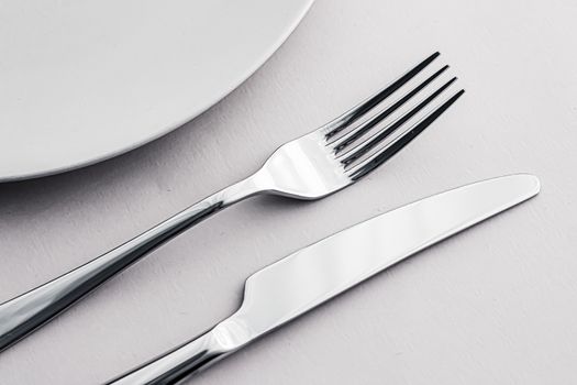 Empty plate and cutlery as mockup set on white background, top tableware for chef table decor and menu branding design