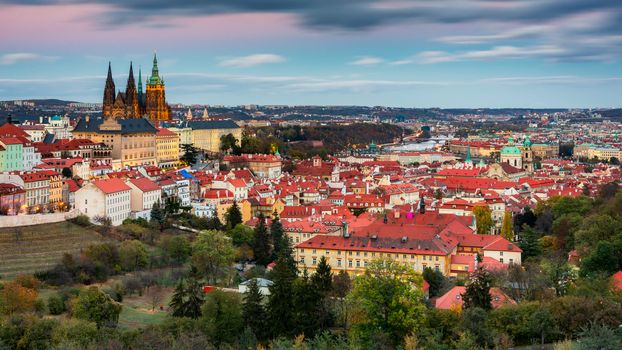 Prague autumn landscape. Prague autumn landscape view to Saint Vitus cathedral. Prague. Prague panorama. Prague, Czech Republic. Scenic autumn aerial view of the Old Town with red foliage. Czechia.