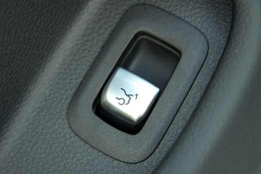 button on the dashboard to open the car trunk