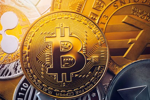 Stack of cryptocurrencies with a golden bitcoin. Bitcoin as most important cryptocurrency concept. Bitcoin. Physical bit coin. Digital currency. Cryptocurrency. Golden coin with bitcoin