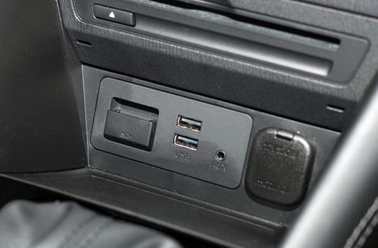 two usb ports on the dashboard of a modern passenger car
