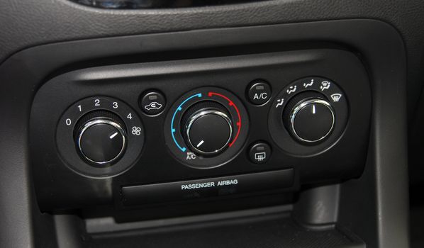 manual switches the air conditioning on the dashboard of the car