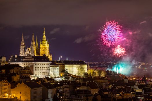 Fireworks over the Old Town of Prague, Czech Republic. New Year fireworks in Prague, Czechia. Prague fireworks during New Year Celebration near St. Vitus Cathedral, Prague, Czech republic.
