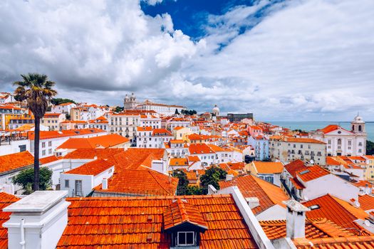 Lisbon, Portugal city skyline over the Alfama district. Summertime sunshine day cityscape in the Alfama, historic old district Alfama in Lisbon, Portugal. Lisbon cityscape in the Alfama District. 