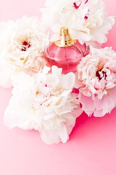Luxurious fragrance bottle as chic perfume product on background of peony flowers, parfum ad and beauty branding design