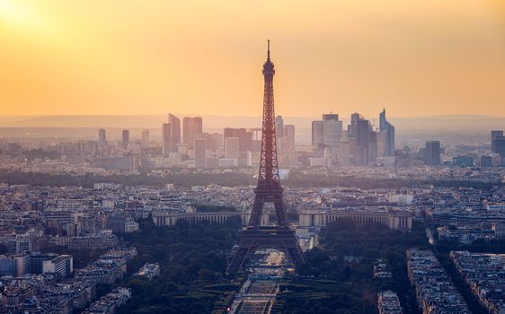 Panoramic aerial view of Paris, Eiffel Tower and La Defense business district. Aerial view of Paris at sunset. Panoramic view of Paris skyline with Eiffel Tower and La Defense. Paris, France. 