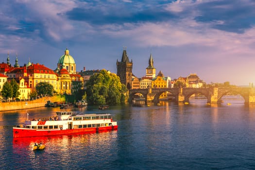 Prague Castle, Charles Bridge and boats on the Vltava river. View of Hradcany Prague Castle, Charles Bridge and a boats on the Vltava river in the capital of the Czechia. Boat cruise on Vltava river.