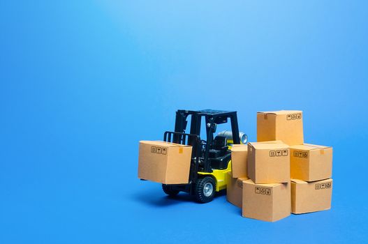 Forklift truck with cardboard boxes. Transportation logistics infrastructure, import and export goods and products delivery. Production, transport, cargo storage. Freight shipping. retail