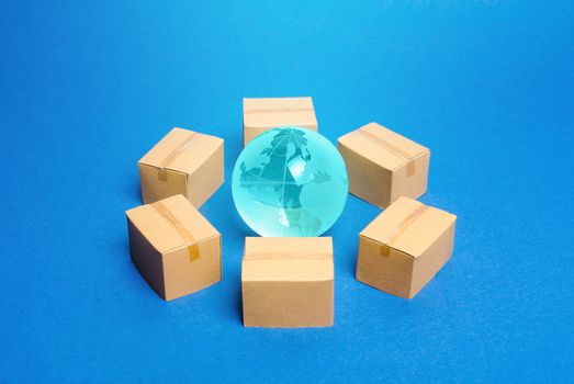 Earth globe is surrounded by boxes. Global business and transportation of goods and products. Shipping and freight, world trade and economics. Distribution, import export. commodity turnover