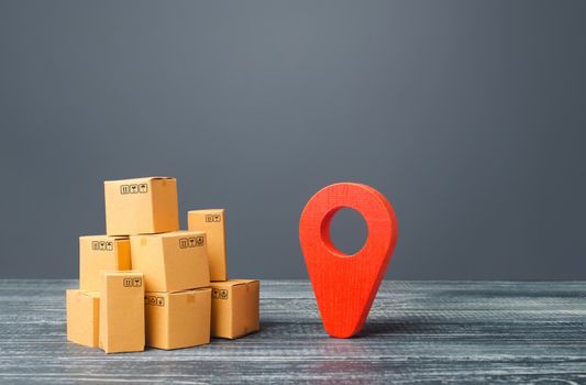 Red location pointer geolocation symbol and cardboard boxes. Distribution delivery of goods, freight transportation shipment. Logistics and warehousing. Global market and business, import and export.