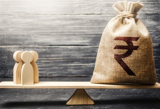 Indian rupee INR symbol on money bag and people on scales. concept attracting investment, business cooperation, crowdfunding and startup. Staff salary specialist services cost. Solvency, taxpayers