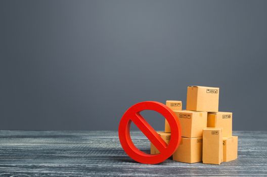 Cardboard boxes and red prohibition symbol NO. Out of stock. Embargo trade wars. Overproduction or scarcity. Restriction on import, ban on export of dual-use goods to countries under sanctions.