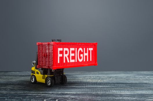 Yellow forklift carries red freight container. Transportation logistics infrastructure, import and export of goods and products. Warehousing. Cargo transit. Powerful economy, world globalization