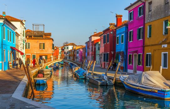 Beautiful view of the canals of Burano with boats and beautiful, colorful buildings. Burano village is famous for its colorful houses. Venice, Italy.