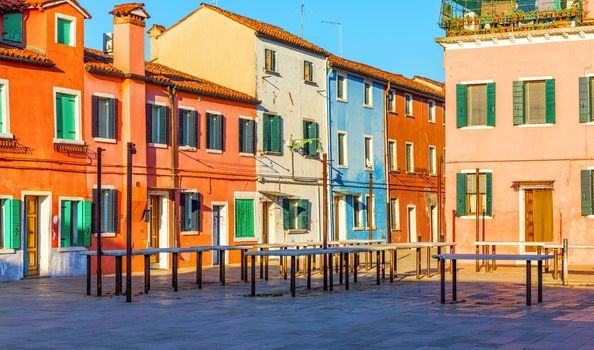 Street with colorful buildings in Burano island, Venice, Italy. Architecture and landmarks of Burano, Venice postcard. Scenic canal and colorful architecture in Burano island near Venice, Italy