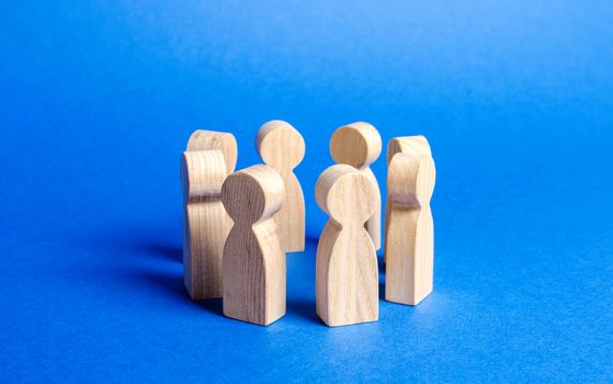 People figurines stand in a circle. discussion, cooperation. Employees briefing. Organization of work and processes. Meeting at work, negotiating a plan of action. teamwork. Society and community.