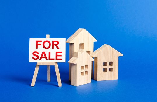 houses and easel FOR SALE. selling a home. Announcement of the sale and attracting potential buyers. Advertising campaign. purchase of real estate.