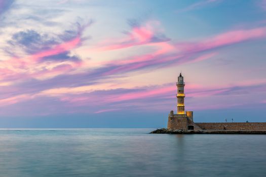 Venetian harbour and lighthouse in old harbour of Chania at sunset, Crete, Greece. Old venetian lighthouse in Chania, Greece. Lighthouse of the old Venetian port in Chania, Greece.