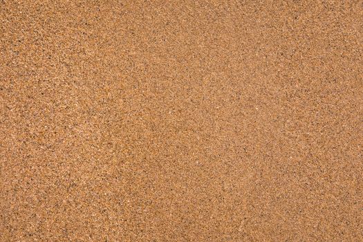 Sand surface and background. Sand Texture. Brown sand. Background from fine sand. Sand background. Closeup of sand pattern of a beach in the summer.