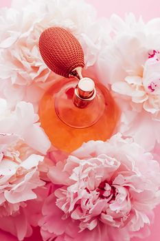 Vintage fragrance bottle as luxe perfume product on background of peony flowers, parfum ad and beauty branding design