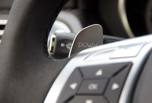 manual gear changing stick on a car's steering wheel, car interior detail