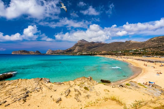 Panorama of turquoise beach Falasarna (Falassarna) in Crete with seagulls flying over, Greece. View of famous paradise sandy deep turquoise beach of Falasarna (Phalasarna), Crete island, Greece.