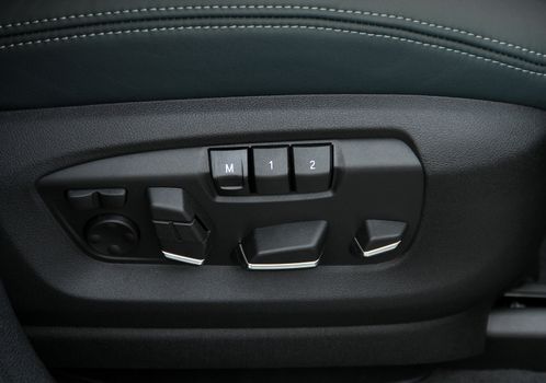 Buttons for adjusting seat position. Car interior detail