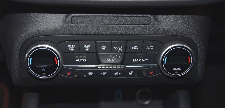 buttons for activating the air conditioners on the dashboard passenger car