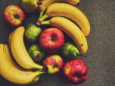 Organic apples, pears and bananas on rustic linen background, fruits farming and agriculture