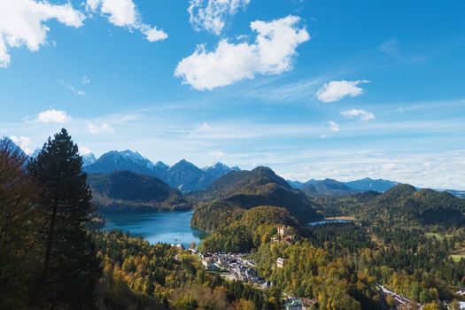 Beautiful nature of European Alps, landscape view of alpine mountains, lake and village on a sunny day, travel and destination scenery