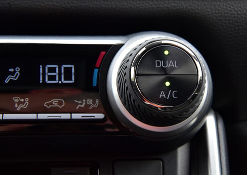 button for activating the air conditioners on the dashboard passenger car