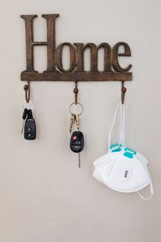 Home Key Hanger Rack Next to Door With Keys and Medical Face Mask During Coronavirus Pandemic.