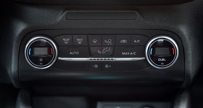 button for activating the air conditioners on the dashboard passenger car