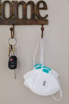 Home Key Hanger Rack Next to Door With Keys and Medical Face Mask During Coronavirus Pandemic.