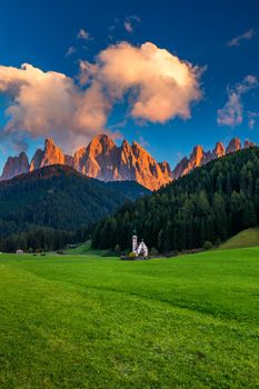 Landscapes with San Giovanni Church and small village in Val di Funes, Dolomite Alps, South Tyrol, Italy, Europe. San Giovanni in Ranui church (St John in Ranui church) in the Dolomites, Italy.