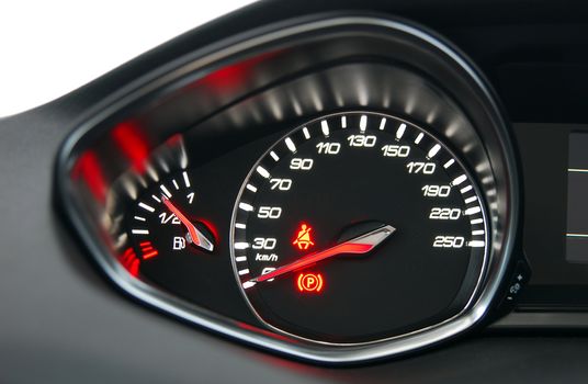 A shot of the car dashboard glowing while stationary