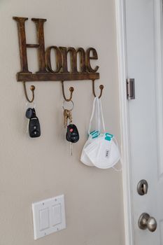 Home Key Hanger Rack Next to Door With Keys and Medical Face Mask During Coronavirus Pandemic.